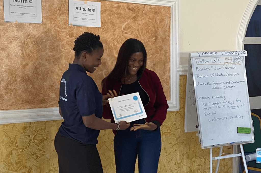 Ngwana Tina Tebe completed the HWTS workshop hosted by RDWB in October 2023 (pictured at right, receiving her certificate from Eboudé Assoué Akwélé). She is an environmental engineering student in Yaoundé, who came to the workshop to learn more about making HWTS accessible to a broader audience. She enjoyed the dynamic nature of the workshop, and commented that the lessons on behavior change would be particularly valuable to her going forward.